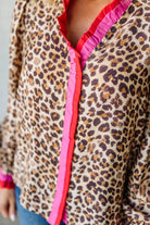 Leopard print jacket with pink trim on a plain background