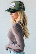 Blonde Woman Wearing A Solid Washed Basic Scoop Neck Ribbed Tee.