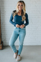 Blonde Woman Wearing A Solid Washed Basic Scoop Neck Ribbed Tee.