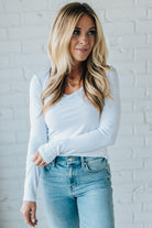 Blonde Woman Wearing A Solid Washed Basic Scoop Neck Ribbed Tee.