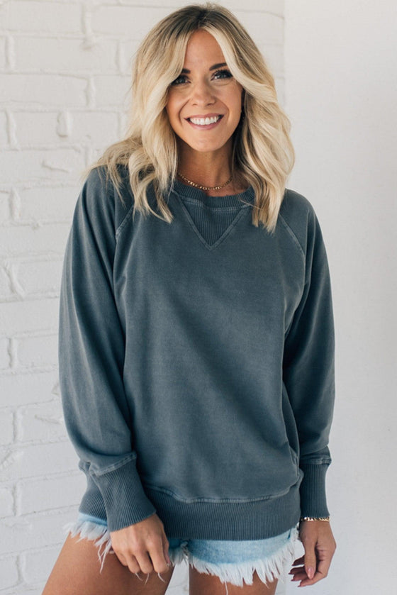 Woman wearing ribbed time sweatshirt with side pockets.