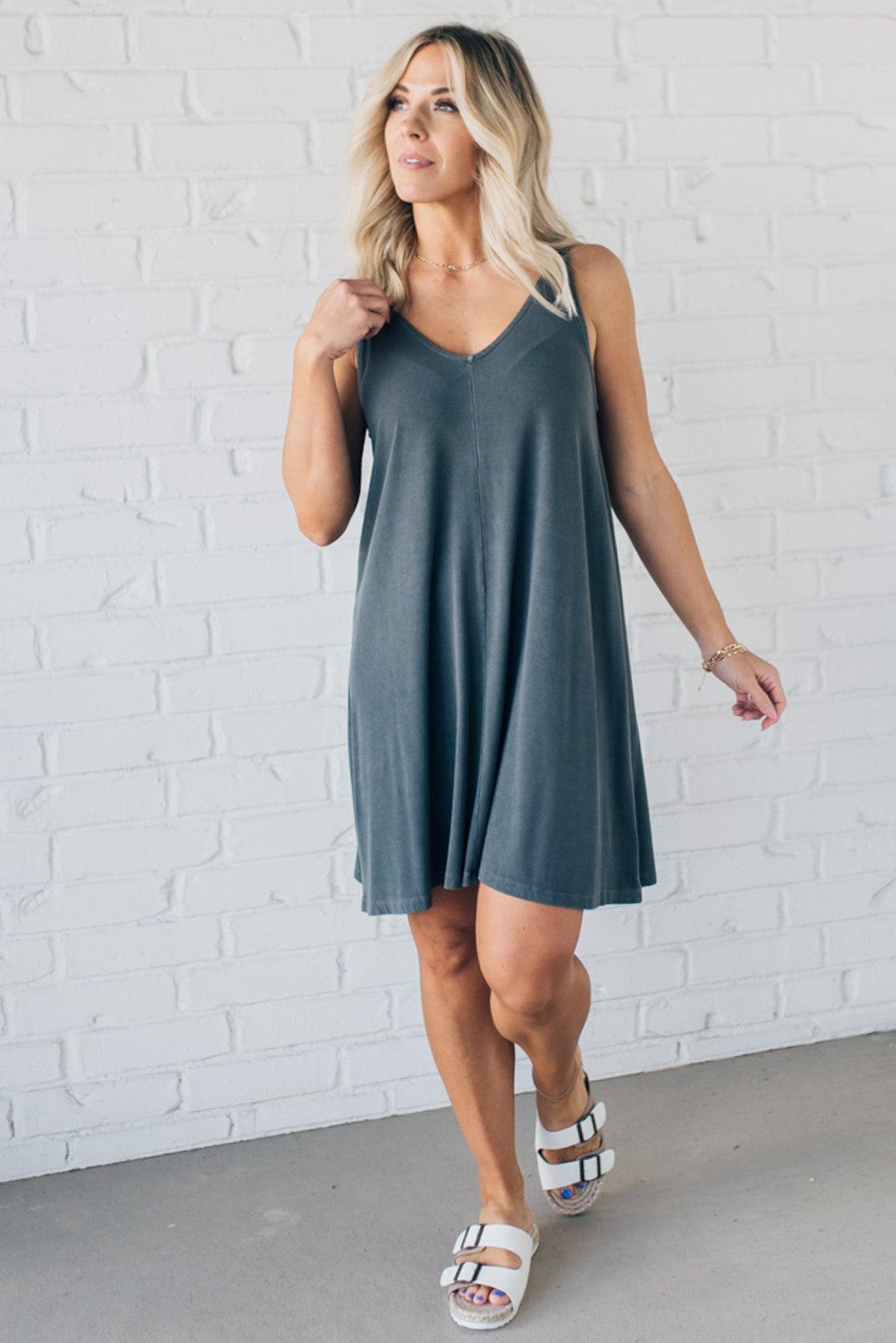 Blonde woman wearing a knee length ribbed kit dress.