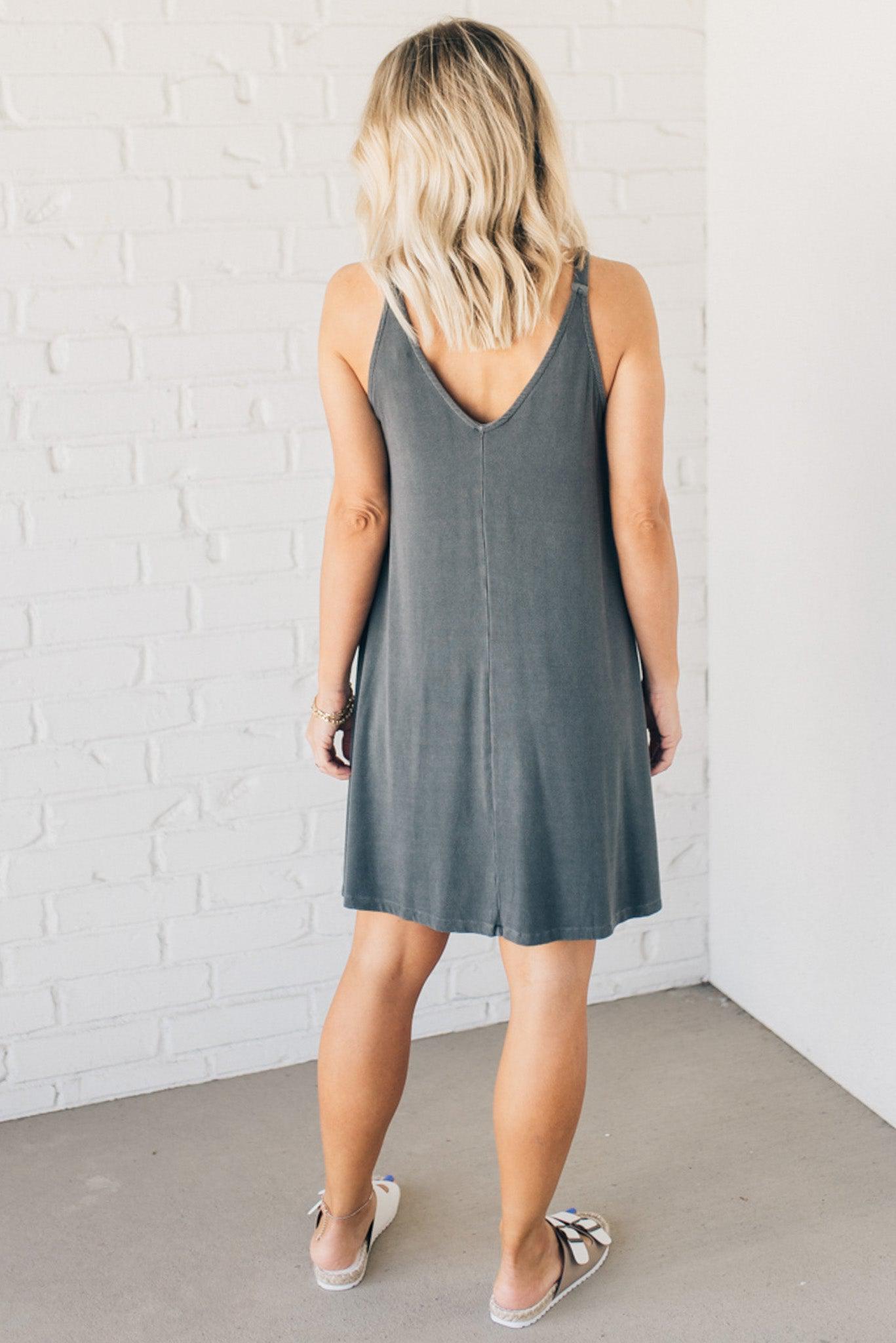 Blonde woman wearing a knee length ribbed kit dress.