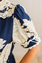 Navy blue and beige floral dress with a close-up of the neckline.