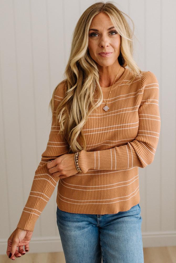 BLONDE WOMAN IN A STUDIO WEARING JEANS AND A BIG BELT WITH A CAMEL RIBBED, LONG SLEEVE, CREW NECK, SUPER STRETCHY BASIC STRIPED INNER SWEATER.