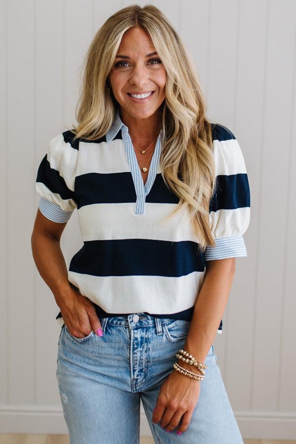 Woman wearing a striped shirt and jeans indoors