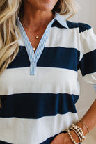 Nautical-style striped shirt with navy and white colors, worn by a person.