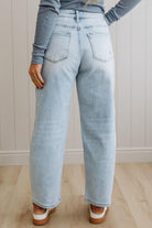 Light blue jeans worn by a person against a neutral background