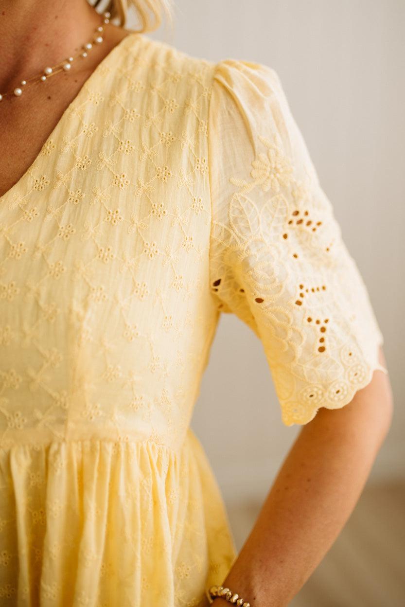 Yellow lace dress with a neutral background