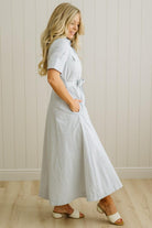 Blonde Woman Wearing a Striped Cotton Button Down Maxi Dress in Light Blue and White Fine Stripes