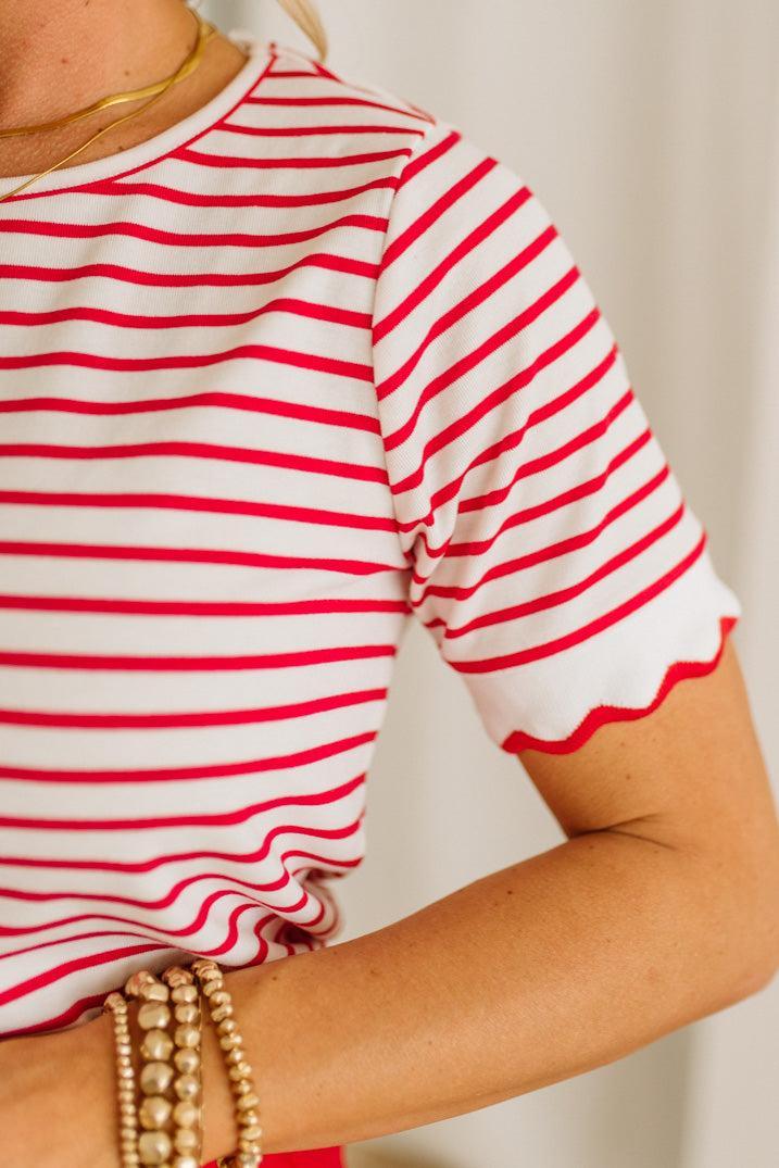 Red and white striped shirt worn by a person with a neutral background