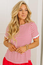 Woman wearing a red and white striped shirt with a plain background