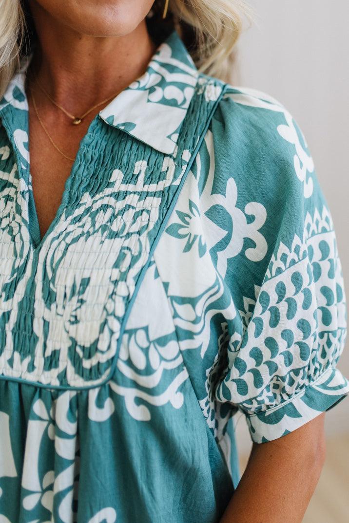 Teal and white patterned dress worn by a person