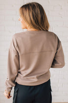 Blonde woman wearing a Soft Scuba Round-Neck Sweatshirt. Crafted from a soft, stretchy scuba fabric, this sweatshirt offers a relaxed fit with a classic round neckline, perfect for everyday wear and laid-back style.