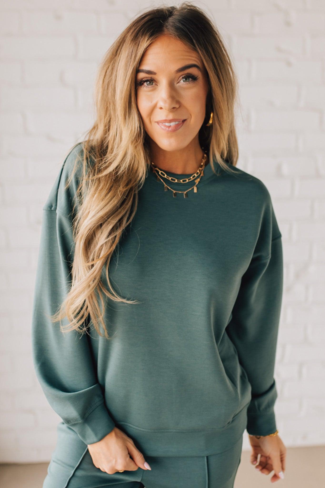 Blonde woman wearing a Soft Scuba Round-Neck Sweatshirt. Crafted from a soft, stretchy scuba fabric, this sweatshirt offers a relaxed fit with a classic round neckline, perfect for everyday wear and laid-back style.