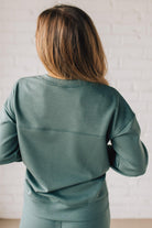 Blonde woman wearing a Soft Scuba Round-Neck Sweatshirt. Crafted from a soft, stretchy scuba fabric, this sweatshirt offers a relaxed fit with a classic round neckline, perfect for everyday wear and laid-back style.