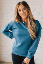 Blonde woman wearing a Soft Scuba Round-Neck Sweatshirt. Crafted from a soft, stretchy scuba fabric, this sweatshirt offers a relaxed fit with a classic round neckline, perfect for everyday wear and laid-back style.