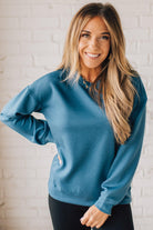 Blonde woman wearing a Soft Scuba Round-Neck Sweatshirt. Crafted from a soft, stretchy scuba fabric, this sweatshirt offers a relaxed fit with a classic round neckline, perfect for everyday wear and laid-back style.