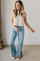 BLONDE WOMAN WEARING DRAWSTRING WAIST DETAIL STRETCH SIDE SLIT WIDE LEG JEAN IN MEDIUM BLUE.