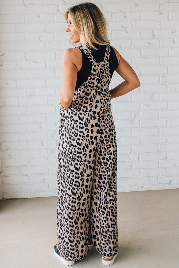 Blonde Woman Wearing Bold Leopard Print Wide Leg Overalls with Side Pockets.