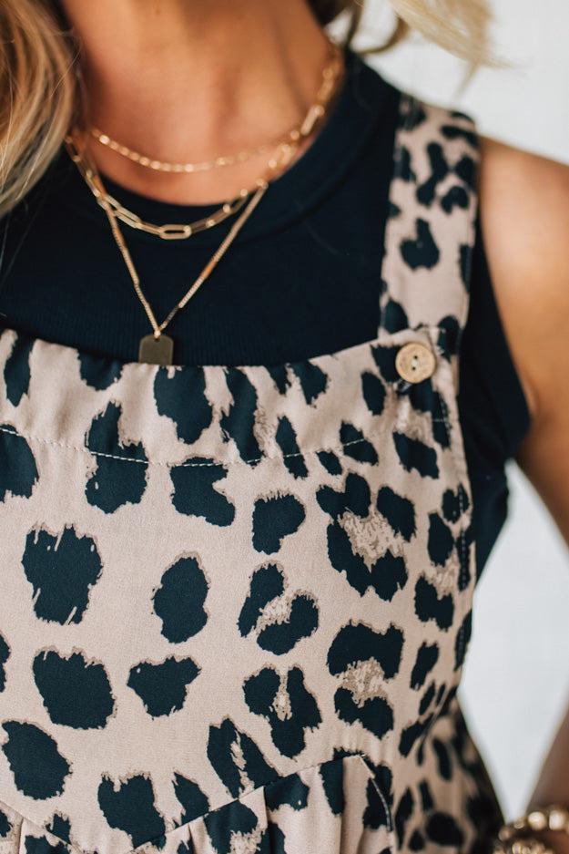Blonde Woman Wearing Bold Leopard Print Wide Leg Overalls with Side Pockets.