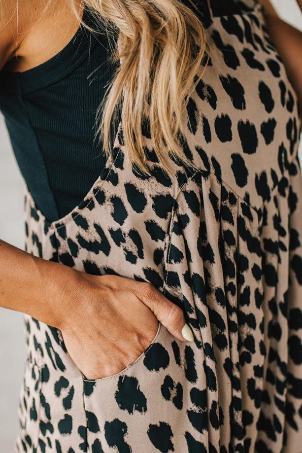 Blonde Woman Wearing Bold Leopard Print Wide Leg Overalls with Side Pockets.