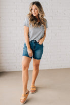 BLONDE WOMAN WEARING A ROUND NECK, SHORT SLEEVE, LOOP TERRY, EVERYDAY LIGHT NAVY STRIPED TOP.