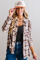 Blonde woman in a bright studio wearing dark jeans and a hat with a Taupe Oversized Flannel Shirt over a charcoal grey tank.