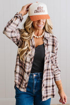 Blonde woman in a bright studio wearing dark jeans and a hat with a Taupe Oversized Flannel Shirt over a charcoal grey tank.