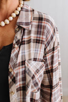 Blonde woman in a bright studio wearing dark jeans and a hat with a Taupe Oversized Flannel Shirt over a charcoal grey tank.