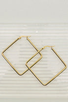 Gold hoop earrings on a light gray background