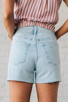 Blonde Woman Wearing a Button Front Faded Red and White Striped Cotton Gauze Front Tie Shirt.