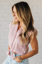 Blonde Woman Wearing a Button Front Faded Red and White Striped Cotton Gauze Front Tie Shirt.