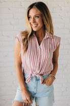 Blonde Woman Wearing a Button Front Faded Red and White Striped Cotton Gauze Front Tie Shirt.
