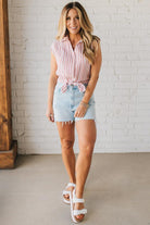 Blonde Woman Wearing a Button Front Faded Red and White Striped Cotton Gauze Front Tie Shirt.
