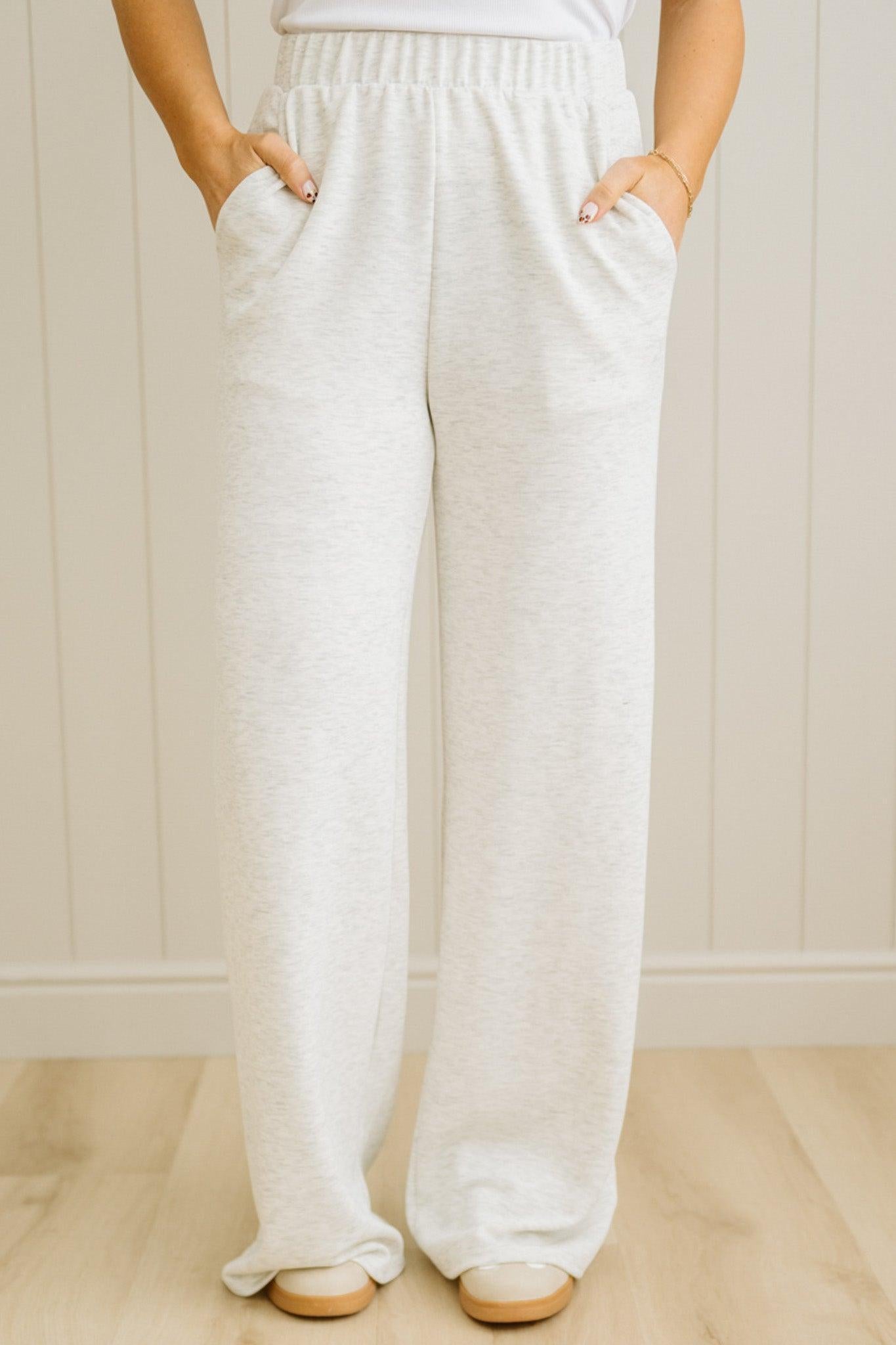 Person wearing white wide-leg pants with a neutral background