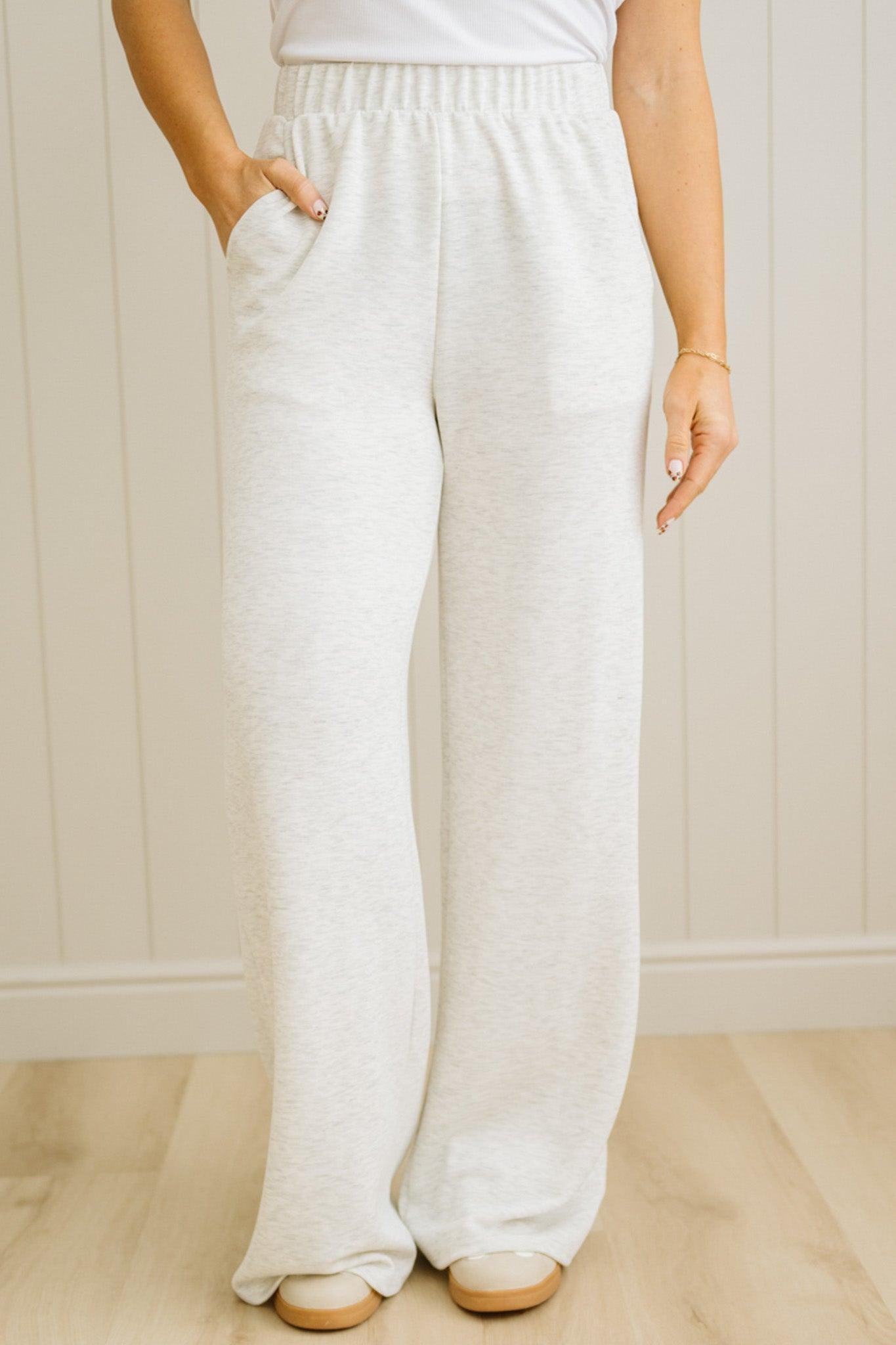 Person wearing white wide-leg pants against a neutral background