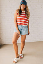Blonde woman in a hat and shorts wearing a red striped sweater tank with double side ties.