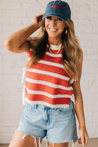 Blonde woman in a hat and shorts wearing a red striped sweater tank with double side ties.