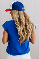 Person wearing a blue cap and shirt with a white background
