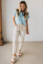 Blonde Woman Wearing a Striped Tencel Button Up Top W/ Rolled Sleeves.