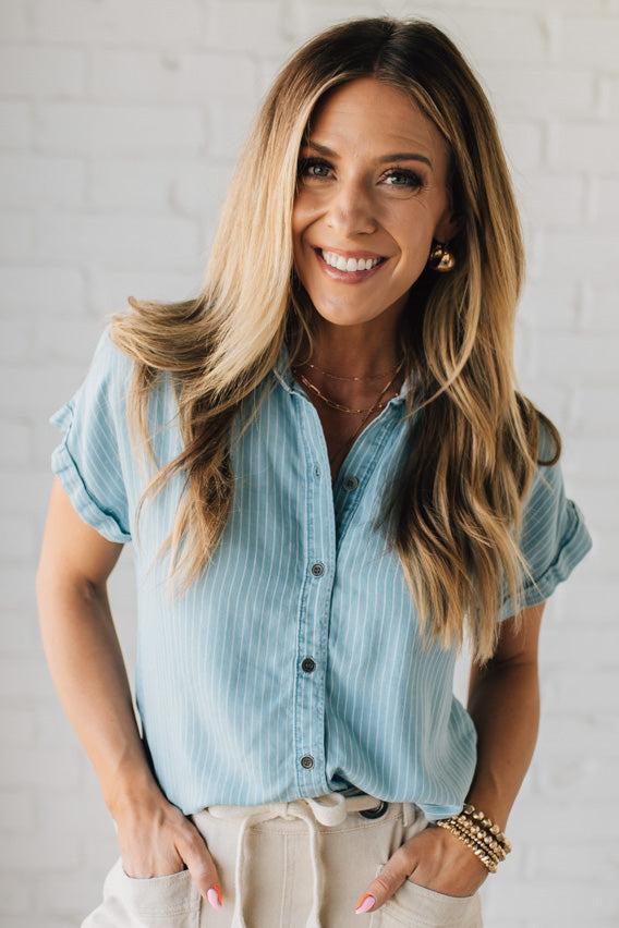 Blonde Woman Wearing a Striped Tencel Button Up Top W/ Rolled Sleeves.