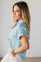 Blonde Woman Wearing a Striped Tencel Button Up Top W/ Rolled Sleeves.