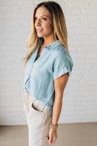 Blonde Woman Wearing a Striped Tencel Button Up Top W/ Rolled Sleeves.