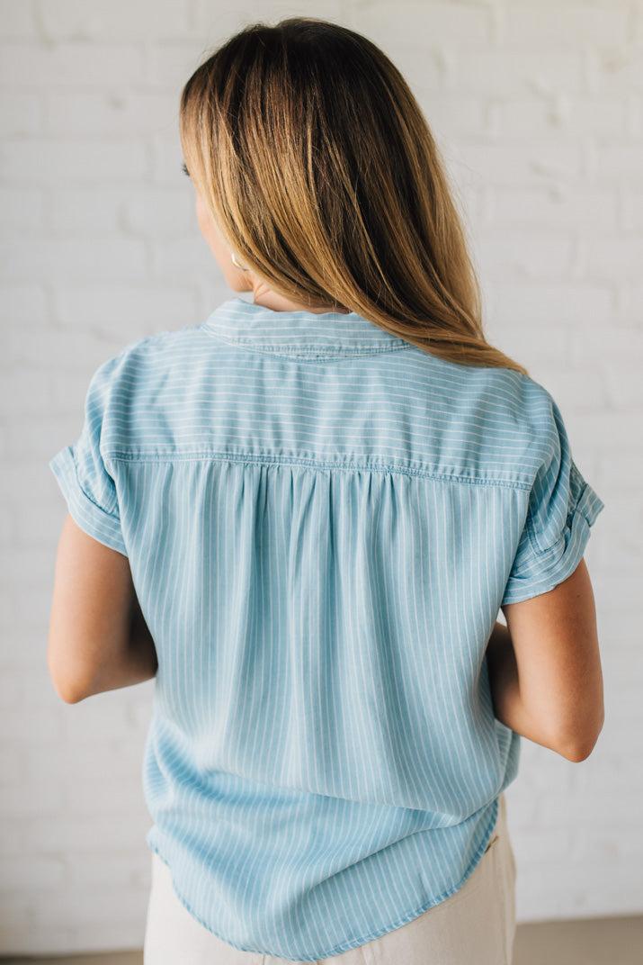 Blonde Woman Wearing a Striped Tencel Button Up Top W/ Rolled Sleeves.