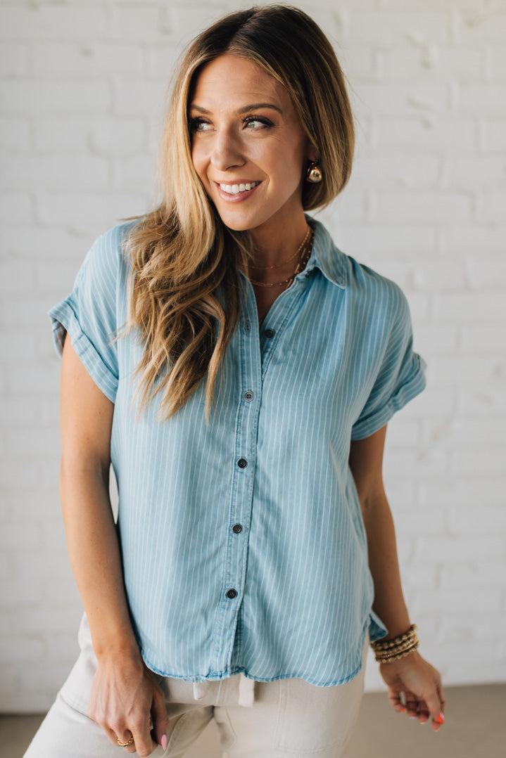 Blonde Woman Wearing a Striped Tencel Button Up Top W/ Rolled Sleeves.