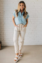 Blonde Woman Wearing a Striped Tencel Button Up Top W/ Rolled Sleeves.
