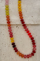 Necklace with multicolored beads on a textured surface