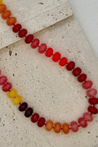 Necklace with multicolored beads on a textured surface