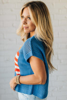 Blonde Woman Wearing a Cobalt Blue Mesh Weave American Flag Open Stitch Sweater Top.